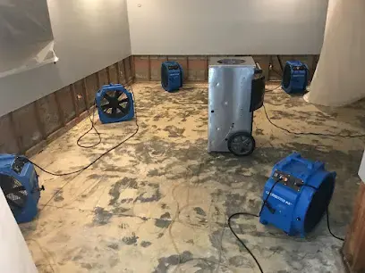 Air movers and a dehumidifier drying a stripped concrete floor in Walnut Creek, CA