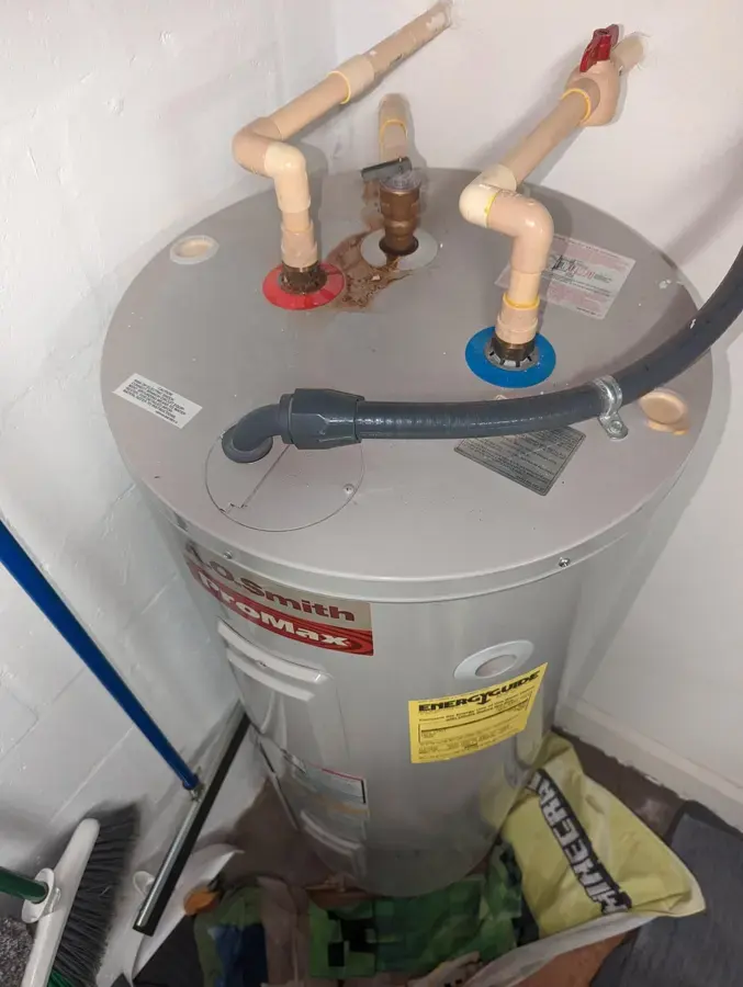 Tank water heater and its supply connections in a closet